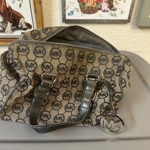 Michael Kors. Tan and grey. Handles are grey. Side has small pockets.